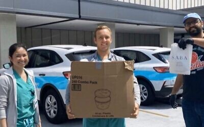 Alon Shaya delivering hummus and pita to medical professionals as part of the @noladocproject. (Saba/ Facebook)