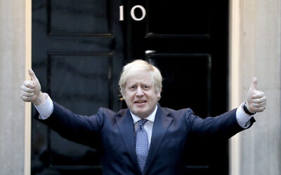 Britain's Prime Minister Boris Johnson shows thumbs up before he applauds on the doorstep of 10 Downing Street in London during the weekly 'Clap for our Carers,' April 30, 2020. (Kirsty Wigglesworth/AP)