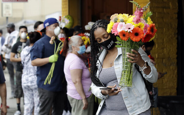 Customers line up to by flowers on Mother's Day at the Los Angeles Flower Market, Sunday, May 10, 2020, in Los Angeles. Families in the U.S. and elsewhere marked Mother's Day in a time of social distancing and isolation due to the coronavirus pandemic. (AP Photo/Marcio Jose Sanchez) Customers line up to by flowers on Mother's Day at the Los Angeles Flower Market, Sunday, May 10, 2020, in Los Angeles. Families in the U.S. and elsewhere marked Mother's Day in a time of social distancing and isolation due to the coronavirus pandemic. (AP Photo/Marcio Jose Sanchez)