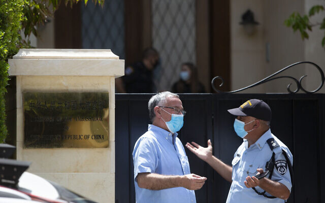 Israeli police officers stand outside the residence of the Chinese ambassador in the central Israeli city of Herzliya, May 17, 2020. (AP Photo/Sebastian Scheiner) Israeli police officers stand outside the residence of the Chinese ambassador in the central Israeli city of Herzliya, May 17, 2020. (AP Photo/Sebastian Scheiner)