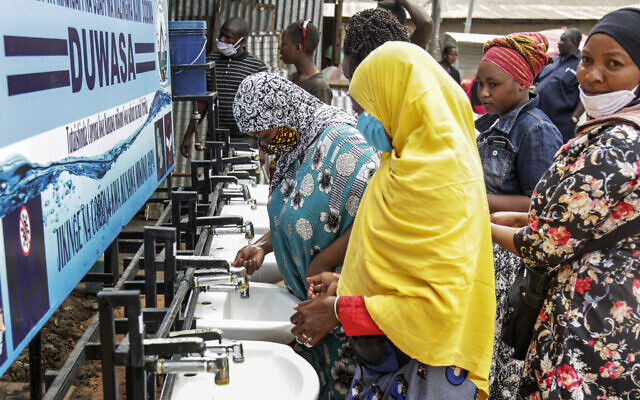 In this photo taken Monday, May 18, 2020, people use a hand-washing station installed for members of the public entering a market in Dodoma, Tanzania. (AP Photo) In this photo taken Monday, May 18, 2020, people use a hand-washing station installed for members of the public entering a market in Dodoma, Tanzania. (AP Photo)