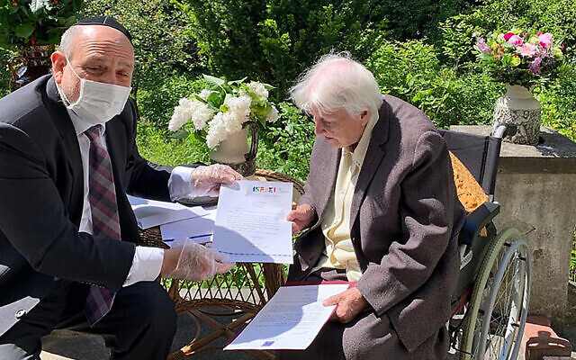 Poland's chief rabbi, Michael Schudrich, delivers letters with birthday greetings from the Israeli and Polish presidents, to Anna Kozminska, a 101-year-old Polish woman who is believed to the be oldest living person recognized by Yad Vashem for rescuing Jews during the Holocaust, in Warsaw, Poland, on Friday, May 22, 2020. (Grazyna Pawlak via AP) Poland's chief rabbi, Michael Schudrich, delivers letters with birthday greetings from the Israeli and Polish presidents, to Anna Kozminska, a 101-year-old Polish woman who is believed to the be oldest living person recognized by Yad Vashem for rescuing Jews during the Holocaust, in Warsaw, Poland, on Friday, May 22, 2020. (Grazyna Pawlak via AP)