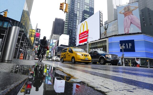 Cars and cyclists move through Times Square after a rain shower during the coronavirus pandemic, May 23, 2020, in New York. (AP Photo/Frank Franklin II) Cars and cyclists move through Times Square after a rain shower during the coronavirus pandemic, May 23, 2020, in New York. (AP Photo/Frank Franklin II)