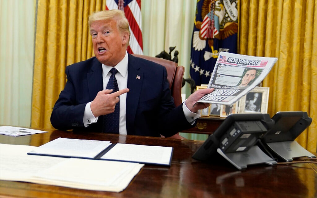 US President Donald Trump holds up a copy of the New York Post as he speaks before signing an executive order aimed at curbing protections for social media giants, in the Oval Office of the White House, Thursday, May 28, 2020, in Washington. (AP Photo/Evan Vucci) US President Donald Trump holds up a copy of the New York Post as he speaks before signing an executive order aimed at curbing protections for social media giants, in the Oval Office of the White House, Thursday, May 28, 2020, in Washington. (AP Photo/Evan Vucci)