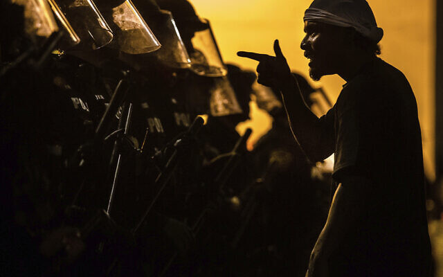 A protester vents at a line of Tucson Police Officers in riot gear at Cushing Street and Church Avenue early on Saturday, May 30, 2020 in Tucson (Josh Galemore/Arizona Daily Star via AP) A protester vents at a line of Tucson Police Officers in riot gear at Cushing Street and Church Avenue early on Saturday, May 30, 2020 in Tucson (Josh Galemore/Arizona Daily Star via AP)