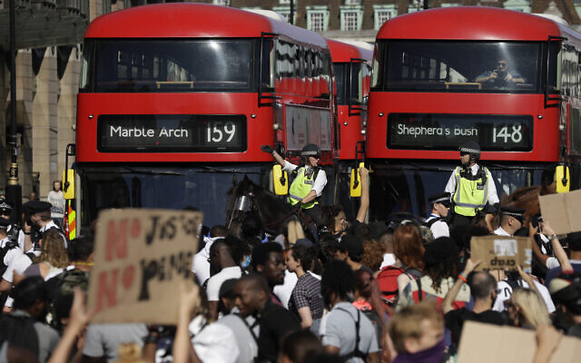 Police officers on horseback stand next to demonstrators blocking the road outside the Houses of Parliament in central London on to protest against the recent killing of George Floyd in Minneapolis, Minnesota, May 31, 2020. (Matt Dunham/AP) Police officers on horseback stand next to demonstrators blocking the road outside the Houses of Parliament in central London on to protest against the recent killing of George Floyd in Minneapolis, Minnesota, May 31, 2020. (Matt Dunham/AP)