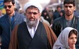 Iran's former intelligence minister Ali Fallahian, escorted by his bodyguards, is seen in Tehran in this Dec. 22, 2000 photo.  (AP Photo/Hasan Sarbakhshian, File)