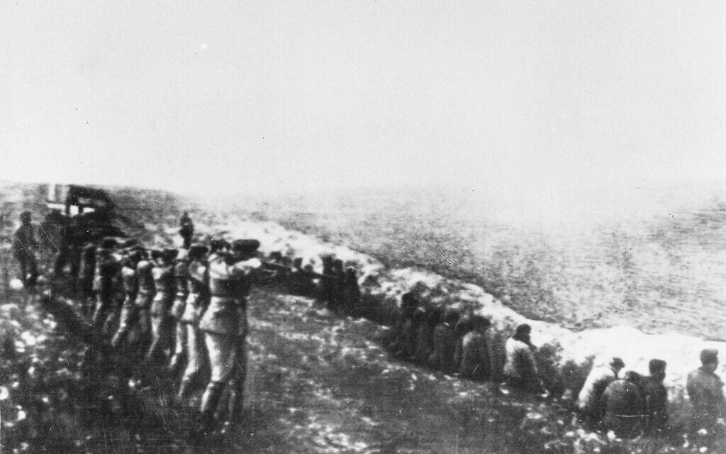 This photo was taken from the body of a dead German officer killed in Russia, showing a German firing squad shooting civilians in the back as they sit beside their own mass grave, in Babi Yar, Kiev, 1942. (AP Photo) This photo was taken from the body of a dead German officer killed in Russia, showing a German firing squad shooting civilians in the back as they sit beside their own mass grave, in Babi Yar, Kiev, 1942. (AP Photo)