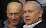 Then-prime minister Benjamin Netanyahu, right, and former prime minister Ehud Olmert, left, attend the funeral of Likud MK Zeev Boim in Binyamina, March 21, 2011. (AP Photo/Moti Milrod, Pool)