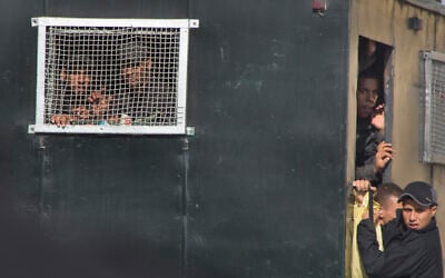 Illustrative: Egyptian soldiers peer out of a police vehicle to watch released detainees outside Tora prison in Cairo, Egypt, Nov.18, 2016. (AP/Amr Nabiln) Illustrative: Egyptian soldiers peer out of a police vehicle to watch released detainees outside Tora prison in Cairo, Egypt, Nov.18, 2016. (AP/Amr Nabiln)
