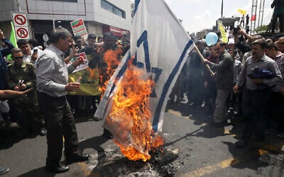 Iranian demonstrators burn a representation of the Israeli flag during their annual protest to mark Quds, or Jerusalem Day, in Tehran, Iran, May 31, 2019 (AP Photo/Vahid Salemi)