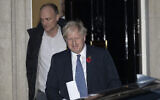 File: Then-British prime minister Boris Johnson and his adviser Dominic Cummings, left, leave 10 Downing Street in London, and get in a car together to go to the Houses of Parliament, Oct. 28, 2019 (AP Photo/Matt Dunham)
