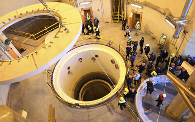 In this photo released by the Atomic Energy Organization of Iran, technicians work at the Arak heavy water reactor's secondary circuit, as officials and media visit the site, near Arak, southwest of the capital Tehran, Iran, Monday, Dec. 23, 2019 (Atomic Energy Organization of Iran via AP)