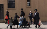 Illustrative: People walk in the Williamsburg neighborhood of Brooklyn, New York, on April 8, 2020. (AP/Mark Lennihan)