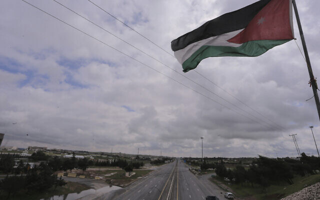A Jordanian flag over a locked down Amman, Jordan on March 21, 2020. (AP/Raad Adayleh)