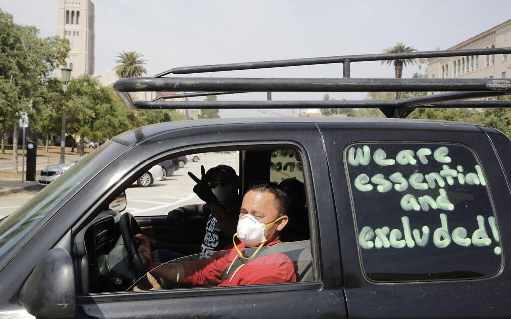 Illustrative: Pasadena day laborers and supporters hold a 'COVID-19-safe car rally' to protest what they say is an exclusion of workers from financial protection in the wake of the current pandemic for essential immigrant workers outside the city hall in Pasadena, California, Wednesday, April 29, 2020. (AP Photo/Damian Dovarganes)