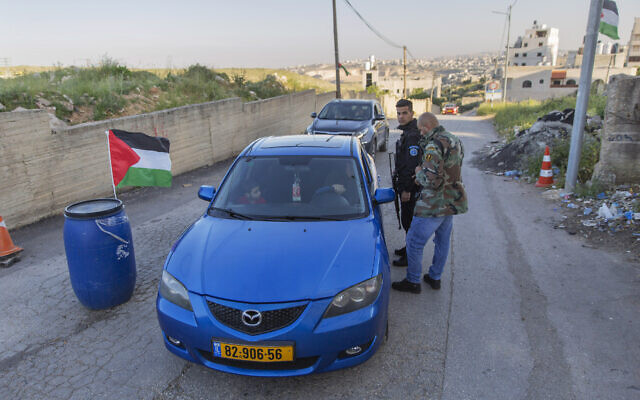In this April 28, 2020 photo, Palestinian security forces stop vehicles, part of lockdown and quarantine measures to protect residents, at a checkpoint on an entrance to the West Bank village of Kafr Aqab, near Ramallah. (AP Photo/Nasser Nasser) In this April 28, 2020 photo, Palestinian security forces stop vehicles, part of lockdown and quarantine measures to protect residents, at a checkpoint on an entrance to the West Bank village of Kafr Aqab, near Ramallah. (AP Photo/Nasser Nasser)