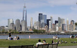 People enjoy the good weather while keeping their distance from one another at Liberty State Park in Jersey City, N.J., Saturday, May 2, 2020. (AP/Seth Wenig)