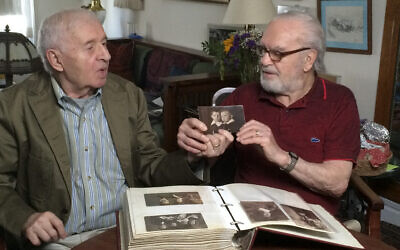 Brothers Alexander Feingold, left, and Joseph Feingold look at photo of themselves as boys in Joseph's apartment in New York on June 8, 2015 (Raphaela Neihausen via AP)
