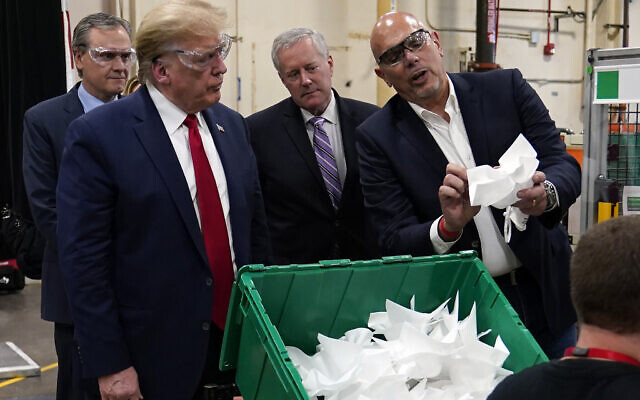US President Donald Trump listens to Tony Stallings, vice president of integrated supply chain at Honeywell International Inc., right, during a tour of a Honeywell International plant that manufactures personal protective equipment, Tuesday, May 5, 2020, in Phoenix. At left is Honeywell CEO Darius Adamczyk and White House chief of staff Mark Meadows. (AP Photo/Evan Vucci) US President Donald Trump listens to Tony Stallings, vice president of integrated supply chain at Honeywell International Inc., right, during a tour of a Honeywell International plant that manufactures personal protective equipment, Tuesday, May 5, 2020, in Phoenix. At left is Honeywell CEO Darius Adamczyk and White House chief of staff Mark Meadows. (AP Photo/Evan Vucci)