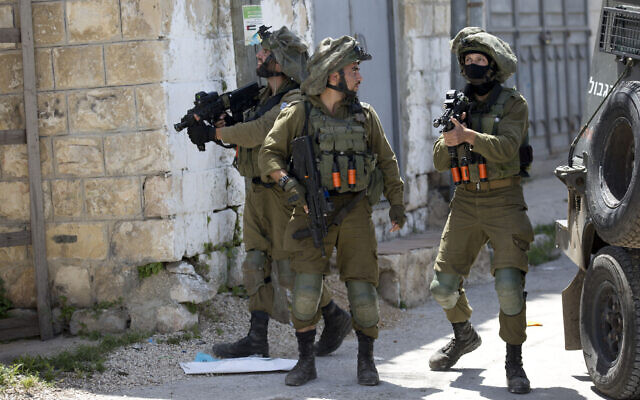 Israeli troops patrol in the northern West Bank village of Yabad after a soldier was killed there during a raid, May, 12, 2020. (AP/Majdi Mohammed) Israeli troops patrol in the northern West Bank village of Yabad after a soldier was killed there during a raid, May, 12, 2020. (AP/Majdi Mohammed)