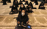 Worshipers wearing protective face masks to help prevent the spread of the coronavirus pray at the mosque of the Tehran University on May 12, 2020. (Vahid Salemi/AP)