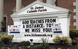 A sign shows at St. James Catholic Parish during the coronavirus pandemic in Arlington Heights, Ill., Thursday, May 14, 2020. The Archdiocese of Chicago, as well as other Catholic dioceses throughout the state announced phased plans to begin reopening Catholic churches, starting in Chicago with small gatherings for baptisms, weddings, funerals and confession as early as May 23. (AP Photo/Nam Y. Huh)