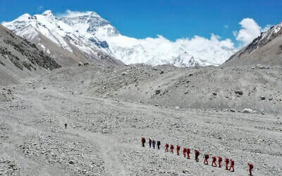 Chinese surveyors hike toward a higher spot from the base camp on Mount Everest at an altitude of 5,200 meters, May 16, 2020. (Jigme Dorje/Xinhua via AP)