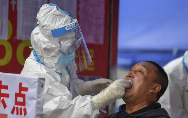 In this May 17, 2020, photo released by Xinhua News Agency, a medical worker collects sample for COVID-19 testing at the Tongji community in Shulan in northeastern China's Jilin Province. Authorities have tightened restrictions in parts of Jilin province in response to a local cluster. (Zhang Nan/Xinhua via AP) In this May 17, 2020, photo released by Xinhua News Agency, a medical worker collects sample for COVID-19 testing at the Tongji community in Shulan in northeastern China's Jilin Province. Authorities have tightened restrictions in parts of Jilin province in response to a local cluster. (Zhang Nan/Xinhua via AP)