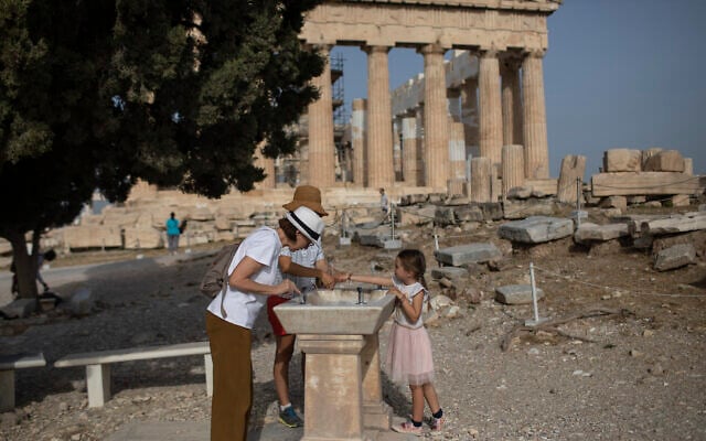 Visitors wash their hands in front of ancient Parthenon temple at the Acropolis hill of Athens, on May 18, 2020 (AP Photo/Petros Giannakouris) Visitors wash their hands in front of ancient Parthenon temple at the Acropolis hill of Athens, on May 18, 2020 (AP Photo/Petros Giannakouris)