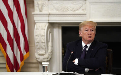 US President Donald Trump listens during a meeting with restaurant industry executives about the coronavirus response, in the State Dining Room of the White House, in Washington, May 18, 2020. (Evan Vucci/Ap)