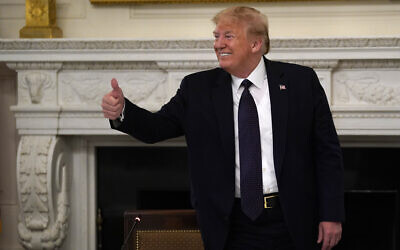 US President Donald Trump gestures as he leaves a meeting with restaurant industry executives about the coronavirus response, in the State Dining Room of the White House, Monday, May 18, 2020, in Washington. (AP Photo/Evan Vucci)