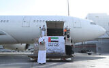 In this photo released by the state-run WAM news agency on May 19, 2020, an Etihad Airways flight with aid for the Palestinians to fight the coronavirus pandemic is loaded with its cargo in Abu Dhabi, United Arab Emirates, before departing to Israel. (WAM via AP)