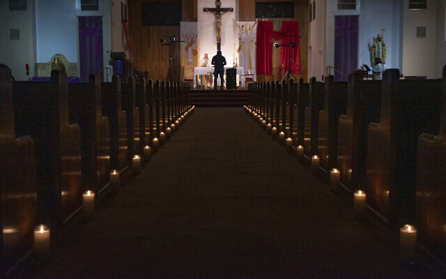 ILLUSTRATIVE - In this April 11, 2020, file photo, a person films Easter Vigil Mass at St. Patrick Church in North Hollywood, California (AP Photo/Damian Dovarganes) ILLUSTRATIVE - In this April 11, 2020, file photo, a person films Easter Vigil Mass at St. Patrick Church in North Hollywood, California (AP Photo/Damian Dovarganes)