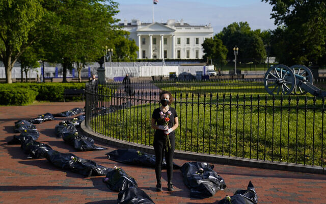 Margot Bloch, of Takoma Park, Md., participates in a protest over President Trump's handling go the coronavirus pandemic, in Lafayette Park across the street from the White House in Washington, Wednesday, May 20, 2020.(AP/Evan Vucci) Margot Bloch, of Takoma Park, Md., participates in a protest over President Trump's handling go the coronavirus pandemic, in Lafayette Park across the street from the White House in Washington, Wednesday, May 20, 2020.(AP/Evan Vucci)