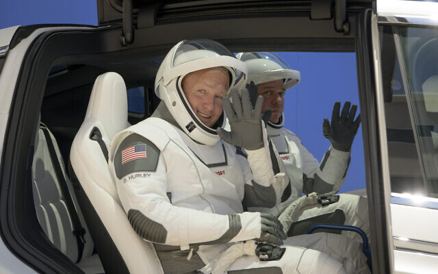 NASA astronauts Douglas Hurley, left, and Robert Behnken, wearing SpaceX spacesuits, depart the Neil A. Armstrong Operations and Checkout Building for Launch Complex 39A during a dress rehearsal prior to the Demo-2 mission launch on May 23, 2020, at NASA's Kennedy Space Center in Cape Canaveral, Florida. (Bill Ingalls/NASA via AP) NASA astronauts Douglas Hurley, left, and Robert Behnken, wearing SpaceX spacesuits, depart the Neil A. Armstrong Operations and Checkout Building for Launch Complex 39A during a dress rehearsal prior to the Demo-2 mission launch on May 23, 2020, at NASA's Kennedy Space Center in Cape Canaveral, Florida. (Bill Ingalls/NASA via AP)