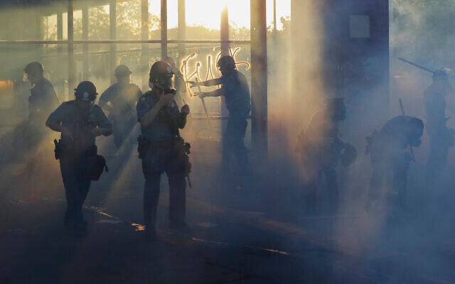 Police move through an area during demonstrations on May 28, 2020, in St. Paul, Minnesota. (AP Photo/Julio Cortez) Police move through an area during demonstrations on May 28, 2020, in St. Paul, Minnesota. (AP Photo/Julio Cortez)