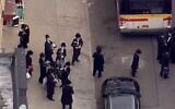 Students leave a yeshiva in Brooklyn after police shut it down for violating coronavirus social distancing regualtions on May 18 2020 (Screencapture/  WNBC-TV)