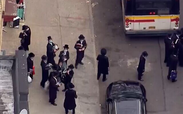 Students leave a yeshiva in Brooklyn after police shut it down for violating coronavirus social distancing regualtions on May 18 2020 (Screencapture/ WNBC-TV) Students leave a yeshiva in Brooklyn after police shut it down for violating coronavirus social distancing regualtions on May 18 2020 (Screencapture/ WNBC-TV)