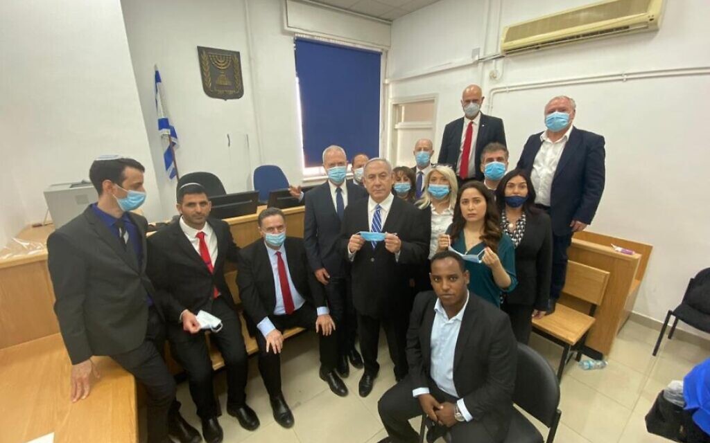 Prime Minister Benjamin Netanyahu (C) stands alongside fellow Likud lawmakers at the Jerusalem District ahead of the opening hearing of his corruption trial on May 24, 2020. With Netanyahu (from left): Ariel Kelner (Likud candidate); Shlomo Karai MK; Finance Minister Israel Katz; Education Minister Yoav Gallant; Nir Barkat MK; Minister without Portfolio Tzachi Hanegbi; Keti Shitrit MK; Gadi Yevarkan MK; Minister of Public Security Amir Ohana; Mai Golan MK; Minister of Intelligence Eli Cohen; Transportation Minister Miri Regev; Minister for Liaison between the Government and the Knesset David Amsalem. (Prime Minister Benjamin Netanyahu/Twitter) Prime Minister Benjamin Netanyahu (C) stands alongside fellow Likud lawmakers at the Jerusalem District ahead of the opening hearing of his corruption trial on May 24, 2020. With Netanyahu (from left): Ariel Kelner (Likud candidate); Shlomo Karai MK; Finance Minister Israel Katz; Education Minister Yoav Gallant; Nir Barkat MK; Minister without Portfolio Tzachi Hanegbi; Keti Shitrit MK; Gadi Yevarkan MK; Minister of Public Security Amir Ohana; Mai Golan MK; Minister of Intelligence Eli Cohen; Transportation Minister Miri Regev; Minister for Liaison between the Government and the Knesset David Amsalem. (Prime Minister Benjamin Netanyahu/Twitter)