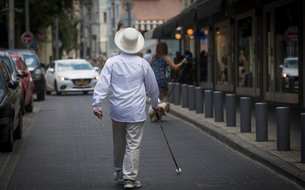 Illustrative: A blind man walks in Tel Aviv on July 23, 2016. (Nati Shohat/Flash90)