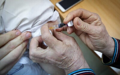 Illustration of a man receiving a vaccine. November 06, 2018. (David Cohen/FLASH90)