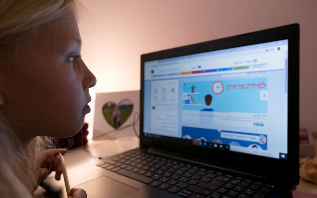 An Israeli chilld during a remote learning class at her home in Moshav Haniel, on March 18, 2020. (Chen Leopold/Flash90) An Israeli chilld during a remote learning class at her home in Moshav Haniel, on March 18, 2020. (Chen Leopold/Flash90)