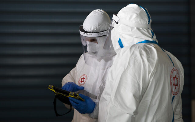 Magen David Adom workers wearing protective clothing seen outside the coronavirus unit at Shaare Zedek hospital in Jerusalem on April 30, 2020 (Nati Shohat/Flash90) Magen David Adom workers wearing protective clothing seen outside the coronavirus unit at Shaare Zedek hospital in Jerusalem on April 30, 2020 (Nati Shohat/Flash90)