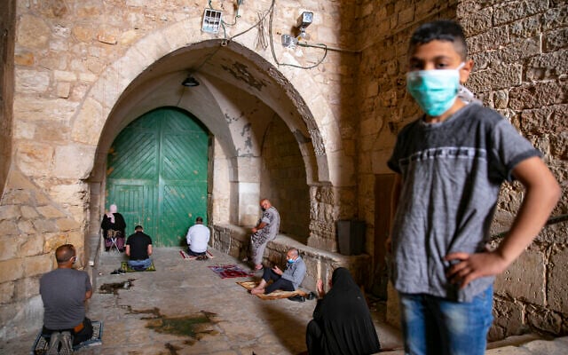 Muslim men pray in the Old City of Jerusalem during the Friday pray of the holy month of Ramadan under restrictions following the spread of the Coronavirus, May 01, 2020.
(Olivier Fitoussi/Flash90)