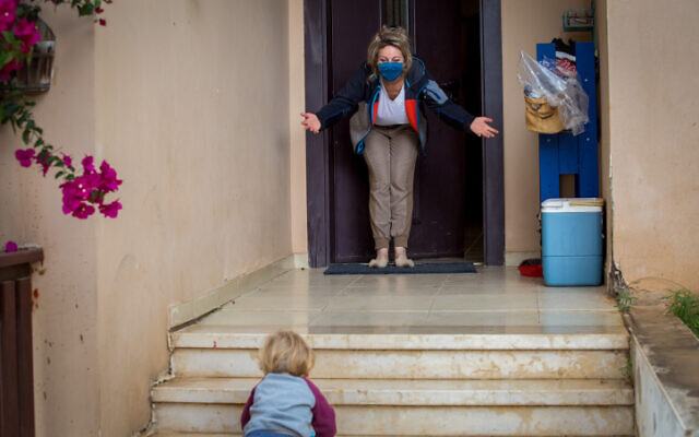 A boy visits his grandmother at her home in Moshav Haniel on April 5, 2020. (Chen Leopold/Flash90) A boy visits his grandmother at her home in Moshav Haniel on April 5, 2020. (Chen Leopold/Flash90)