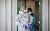 Medical workers stand outside the coronavirus unit at Shaare Zedek Medical Center in Jerusalem on May 5, 2020. (Nati Shohat/Flash90)