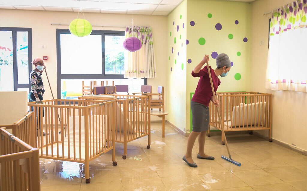 Staff clean a classroom at Emunah daycare in the city of Modiin, on May 7, 2020. (Yossi Zeliger/Flash90) Staff clean a classroom at Emunah daycare in the city of Modiin, on May 7, 2020. (Yossi Zeliger/Flash90)