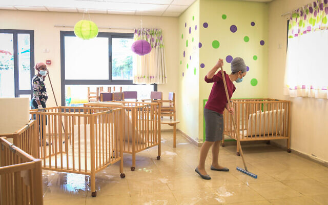 Staff clean a classroom at Emunah daycare in the city of Modiin, on May 7, 2020. (Yossi Zeliger/Flash90) Staff clean a classroom at Emunah daycare in the city of Modiin, on May 7, 2020. (Yossi Zeliger/Flash90)