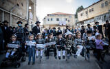 Ultra-Orthodox men and their three-years-old boys take part in a protest against the government restrictions that prevent them from reaching Mount Meron on Lag B'Omer, in the Jerusalem neighborhood of Mea Shearim on May 10, 2020 (Yonatan Sindel/Flash90)